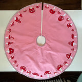 Pink felt tree skirt with mushroom appliques and silver trim by Heather Donohue Crafts LLC.